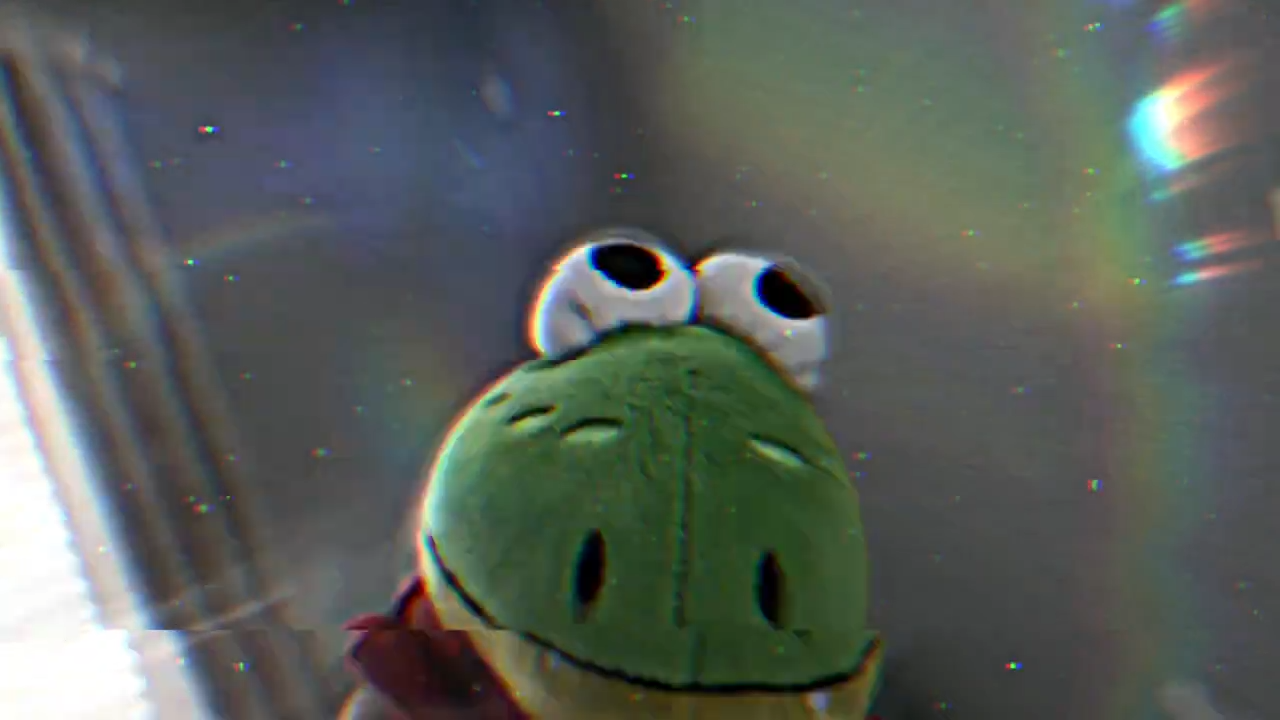 Green plush character close up