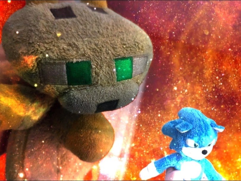 Green plush character surrounded by embers